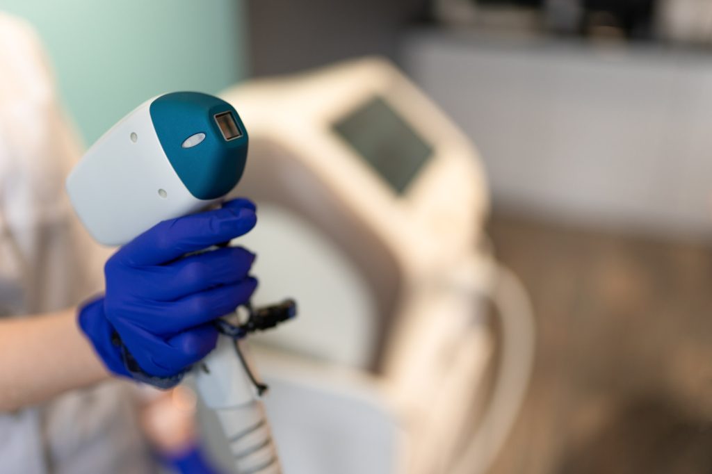 Cosmetologist with a laser for hair removal